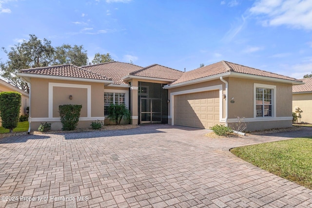 mediterranean / spanish-style house with a garage