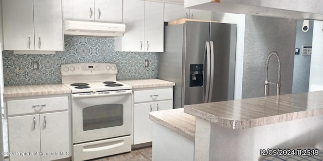 kitchen featuring electric stove, stainless steel fridge with ice dispenser, decorative backsplash, light tile patterned flooring, and white cabinetry