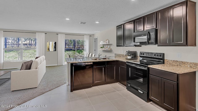 kitchen with dark brown cabinetry, sink, light colored carpet, a textured ceiling, and black appliances