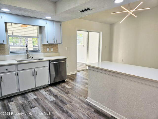 kitchen featuring dishwasher, a wealth of natural light, dark wood-type flooring, and sink