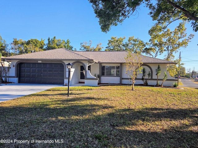 single story home with a front yard and a garage