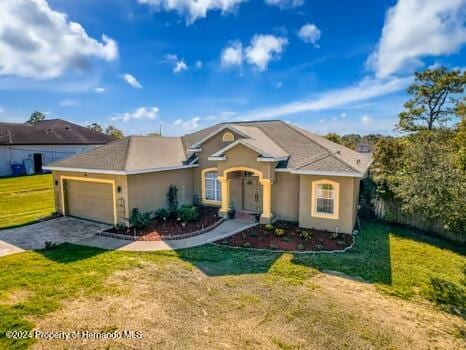 ranch-style home with a front yard and a garage