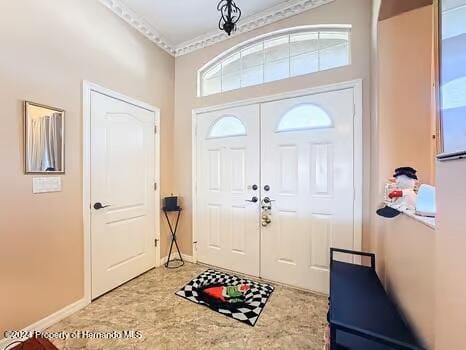 foyer featuring crown molding