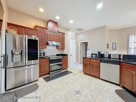 kitchen featuring light tile patterned floors and stainless steel appliances