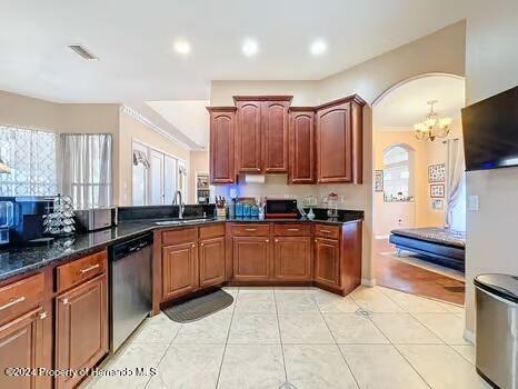 kitchen with dishwasher, light tile patterned floors, an inviting chandelier, and sink