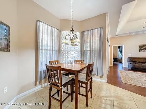 dining space with a chandelier and light wood-type flooring