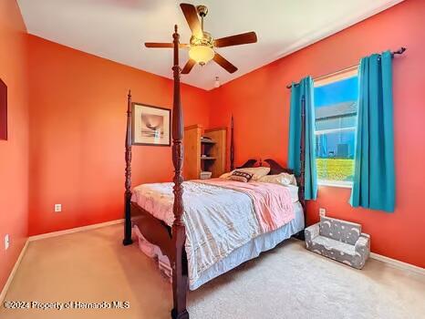 carpeted bedroom featuring ceiling fan