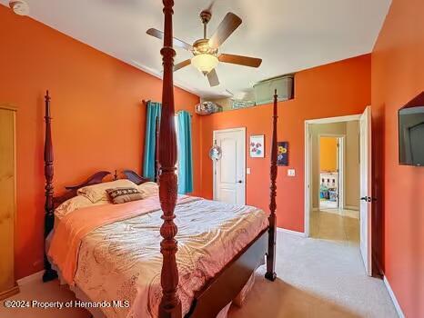 bedroom with ceiling fan and light colored carpet