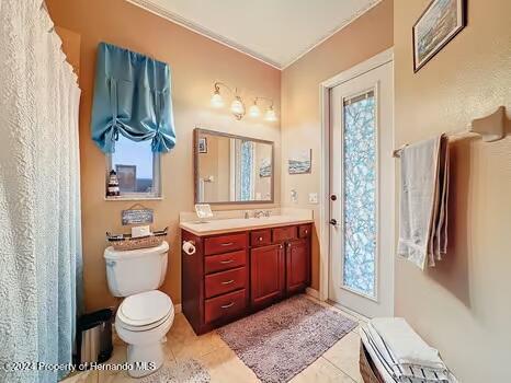 bathroom featuring tile patterned flooring, vanity, and toilet