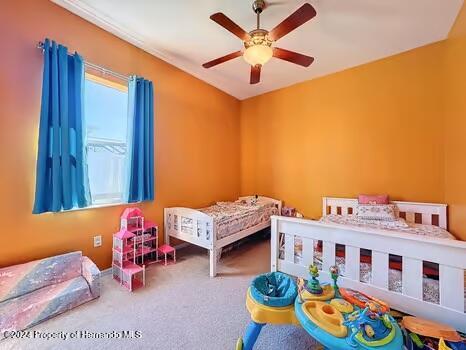 carpeted bedroom with ceiling fan