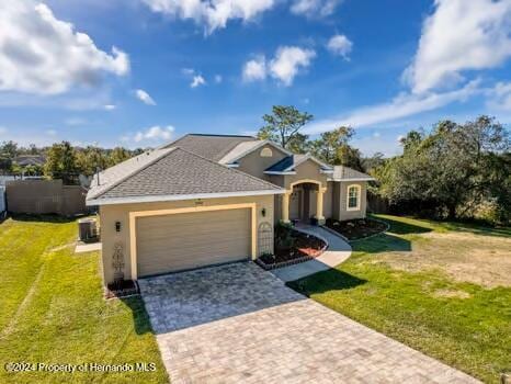 view of front of house with a garage and a front yard