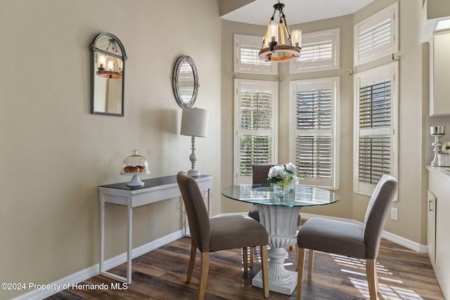 dining room featuring a notable chandelier and dark hardwood / wood-style floors