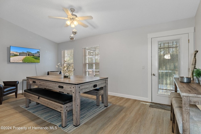 dining room with vaulted ceiling, light hardwood / wood-style flooring, and ceiling fan