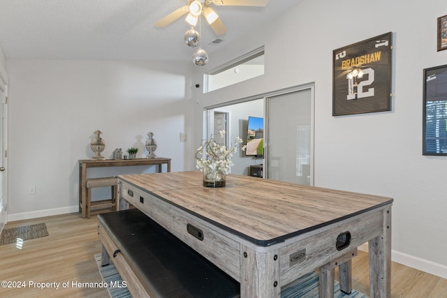 dining room featuring a textured ceiling, light hardwood / wood-style flooring, and ceiling fan