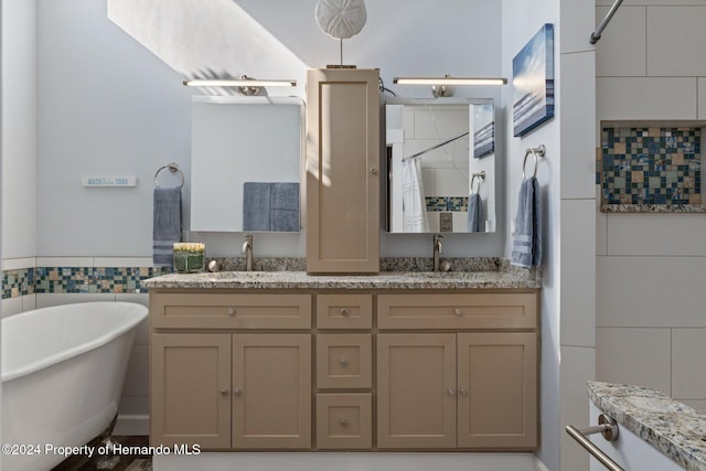 bathroom with plus walk in shower, vanity, and tile walls