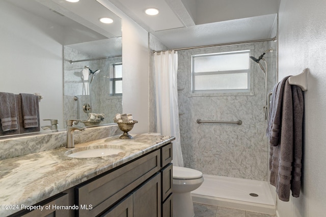 bathroom with tile patterned flooring, vanity, toilet, and a shower with shower curtain