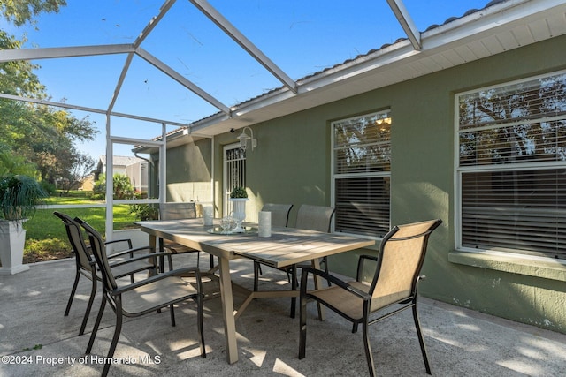 view of patio / terrace featuring glass enclosure