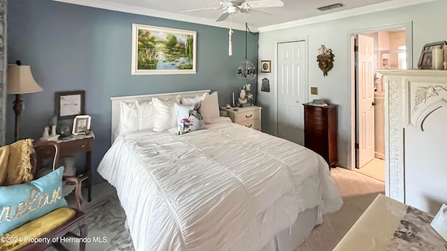 bedroom featuring ceiling fan, light colored carpet, crown molding, and a closet