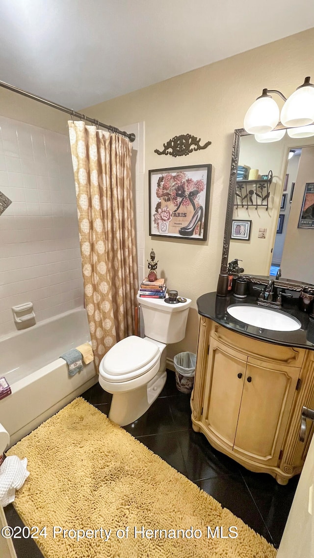 full bathroom with shower / tub combo with curtain, vanity, tile patterned floors, and toilet