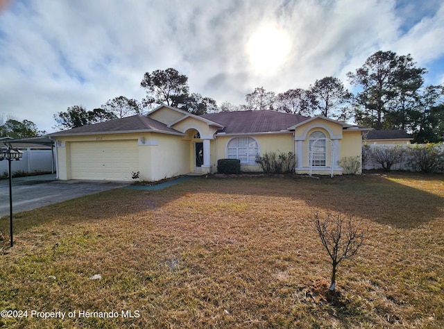 ranch-style home with a front yard and a garage