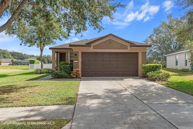 view of front of house with a garage and a front yard