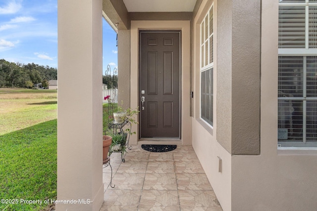 property entrance featuring a yard