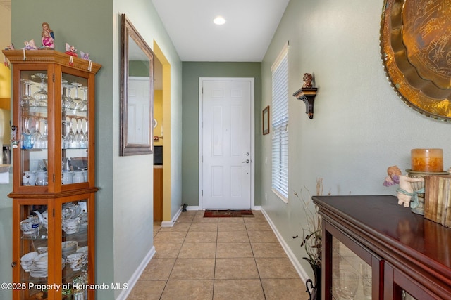 doorway to outside with light tile patterned floors