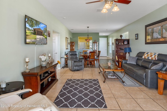 tiled living room with ceiling fan