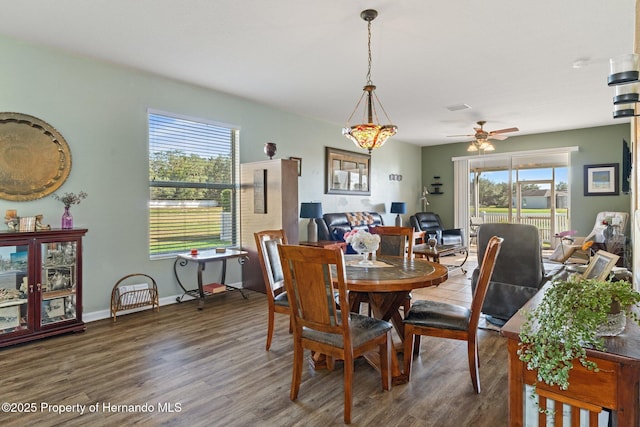 dining area featuring ceiling fan and dark hardwood / wood-style floors