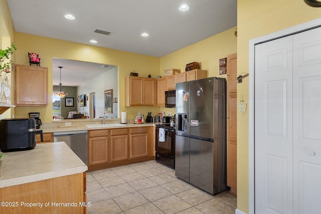 kitchen featuring sink, decorative light fixtures, light tile patterned floors, kitchen peninsula, and black appliances