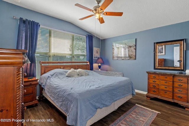 bedroom featuring lofted ceiling, dark hardwood / wood-style flooring, and ceiling fan