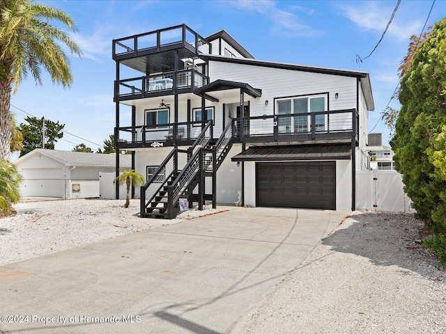 view of front of house with a porch, a balcony, and a garage