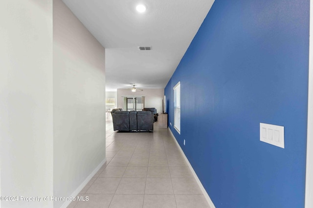 hall with light tile patterned floors