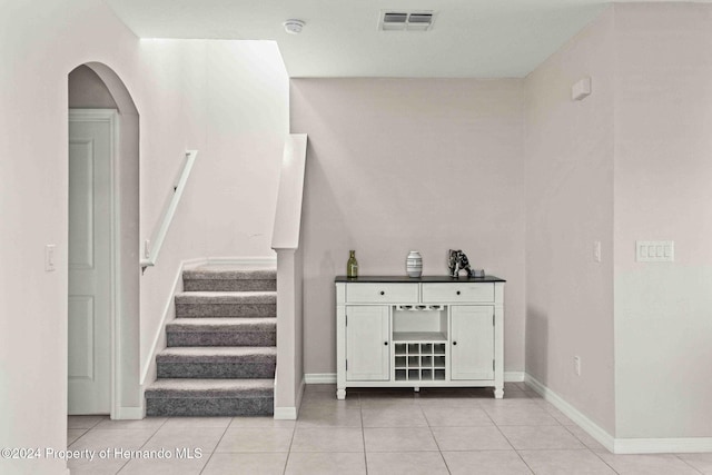 stairway with tile patterned flooring