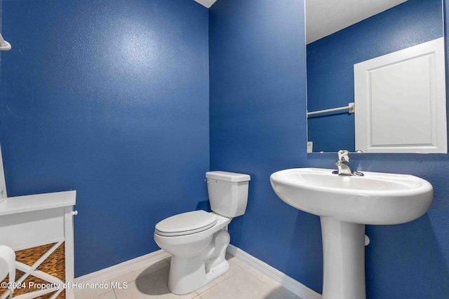 bathroom with tile patterned flooring and toilet