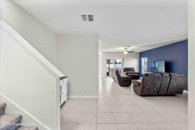 stairs with tile patterned floors and ceiling fan