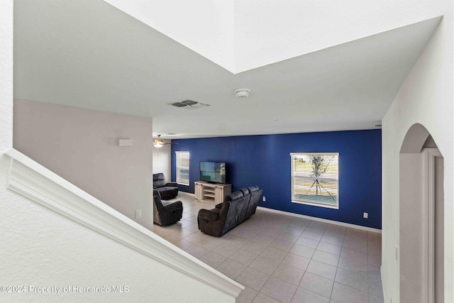 living room with tile patterned flooring and ceiling fan