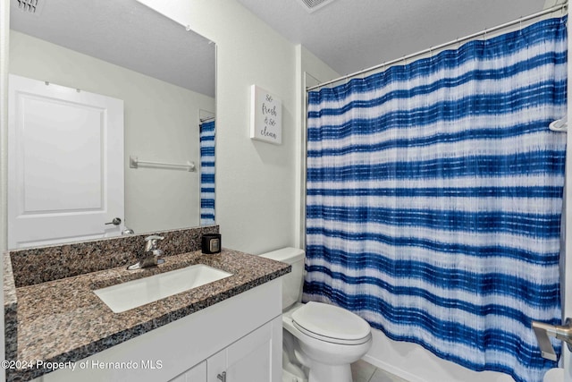 full bathroom with tile patterned flooring, a textured ceiling, toilet, shower / bath combo with shower curtain, and vanity