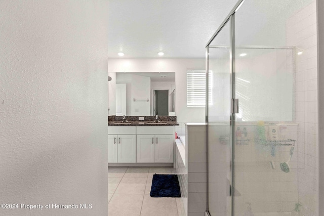 bathroom with vanity, tile patterned floors, and a shower with door