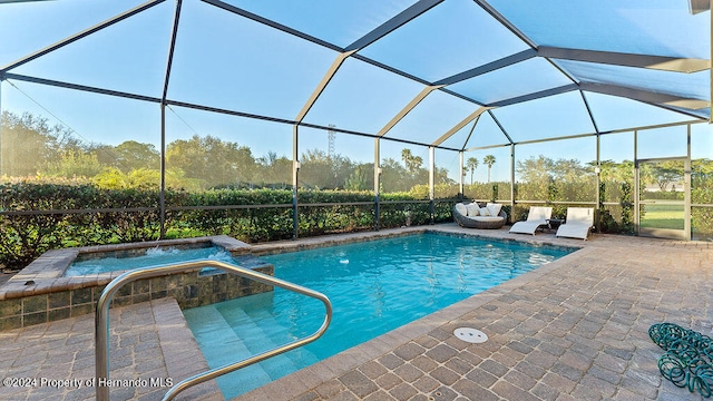 view of swimming pool with a lanai and a patio area