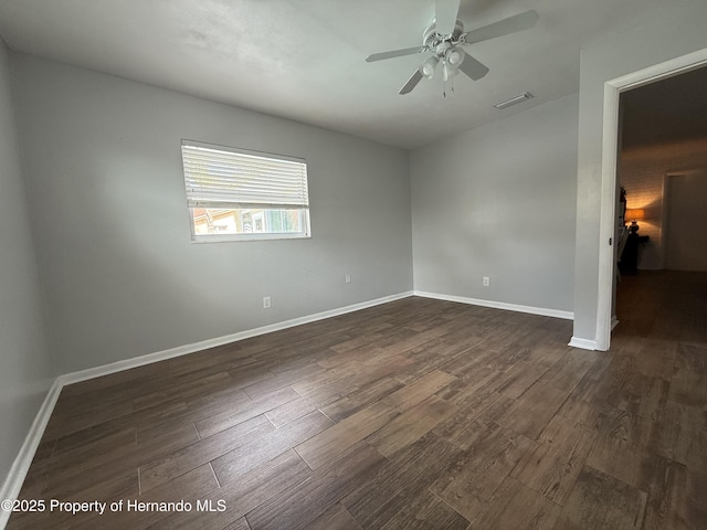 empty room featuring ceiling fan and dark hardwood / wood-style flooring