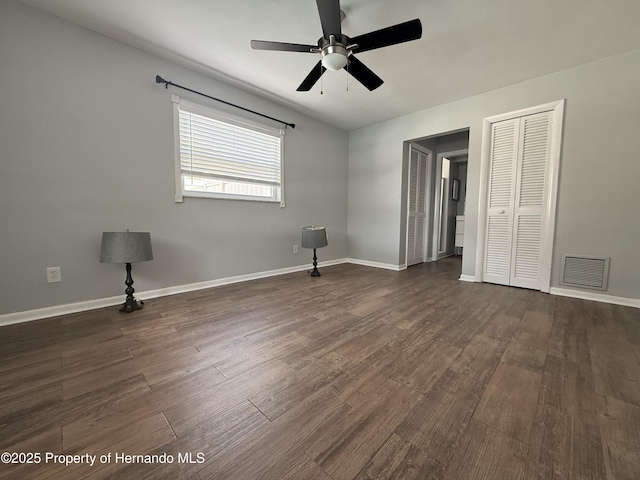 spare room with ceiling fan and dark hardwood / wood-style floors