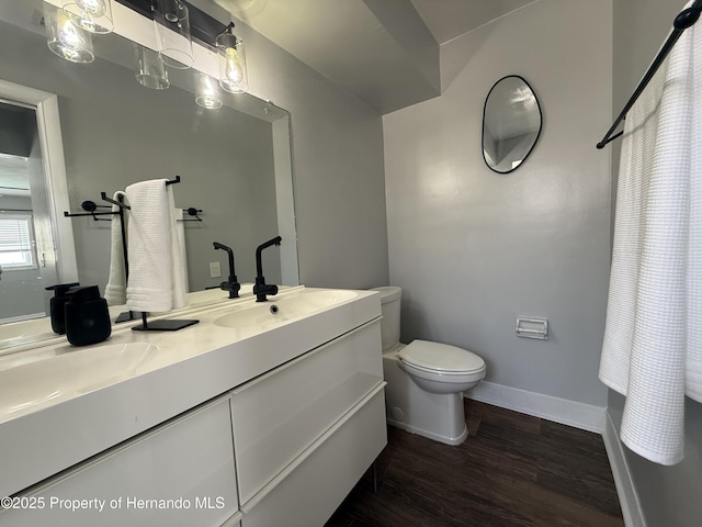 bathroom featuring hardwood / wood-style flooring, vanity, and toilet