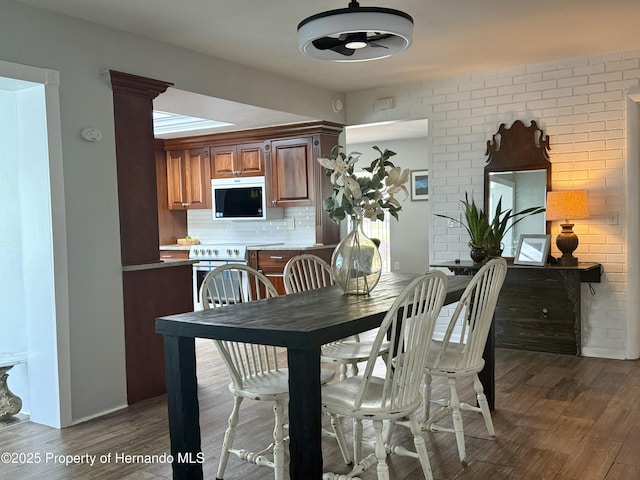 dining space with dark wood-type flooring