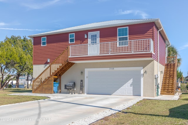 view of front of home with a balcony and a garage