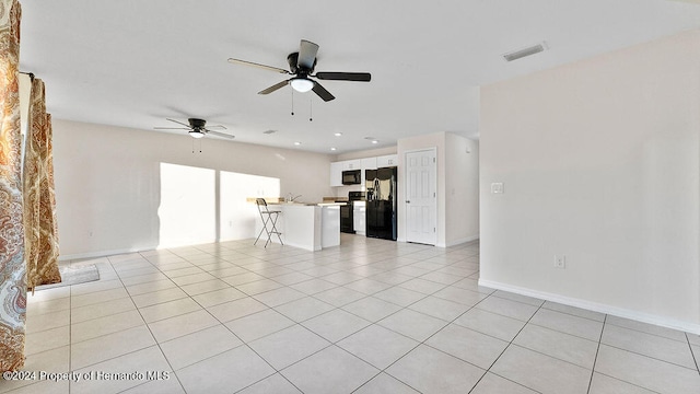 unfurnished living room with ceiling fan and light tile patterned flooring