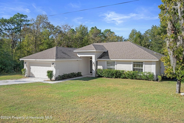 view of front of property with a front yard and a garage