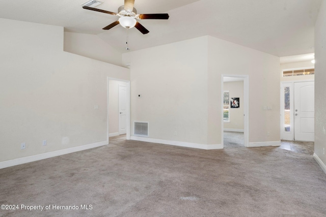 carpeted spare room with vaulted ceiling and ceiling fan