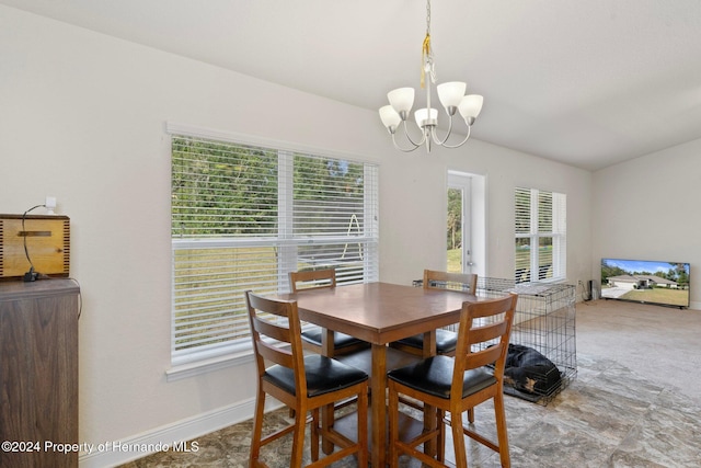 carpeted dining space with a healthy amount of sunlight and a notable chandelier