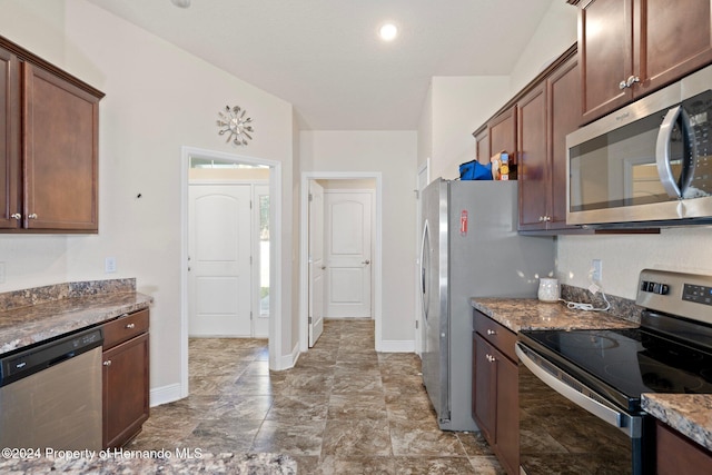 kitchen featuring stone counters and appliances with stainless steel finishes